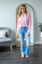 Load image into Gallery viewer, Model standing wearing pink long sleeve shirt and jeans.

